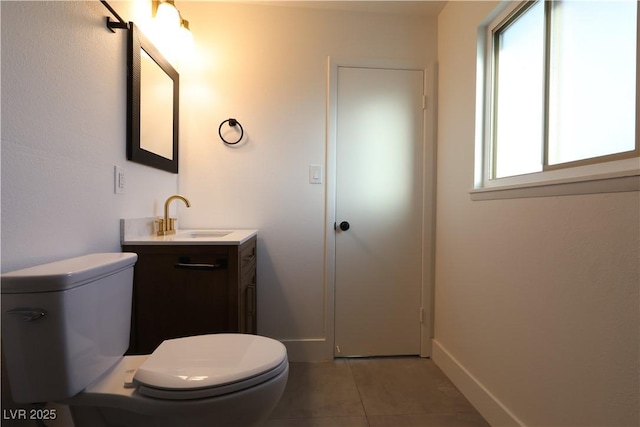 bathroom with vanity, tile patterned flooring, toilet, and baseboards