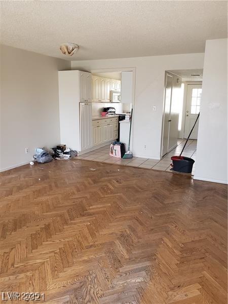 unfurnished room with a textured ceiling