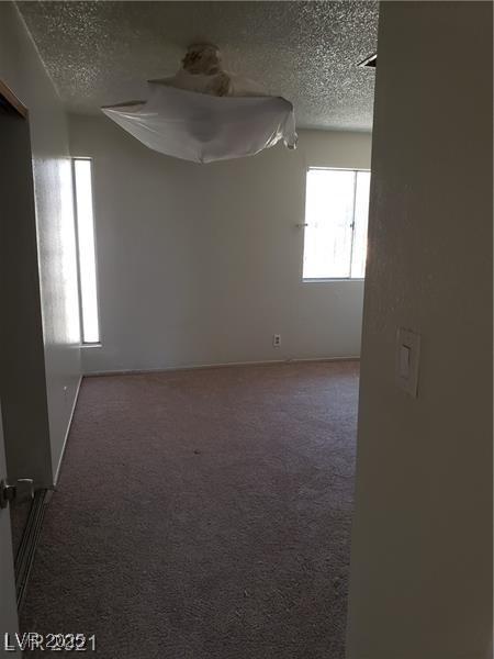 spare room with carpet floors and a textured ceiling