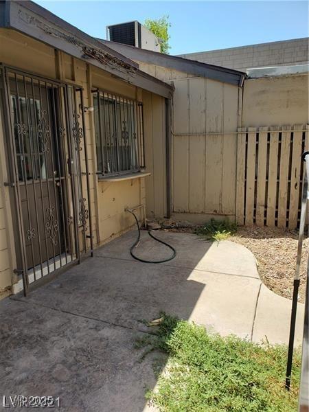 view of patio with fence and central AC unit