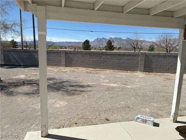 view of yard with a fenced backyard and a mountain view