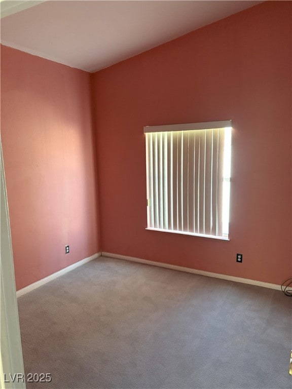 carpeted empty room with baseboards