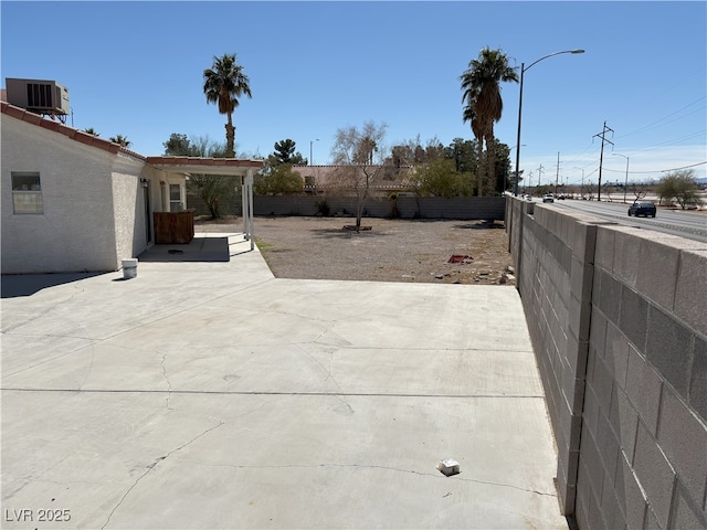 view of patio / terrace with a fenced backyard and central AC unit