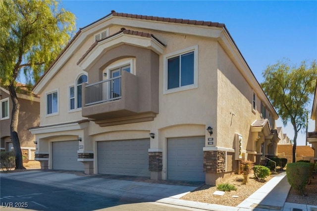 view of front of property with stucco siding, a garage, concrete driveway, and stone siding