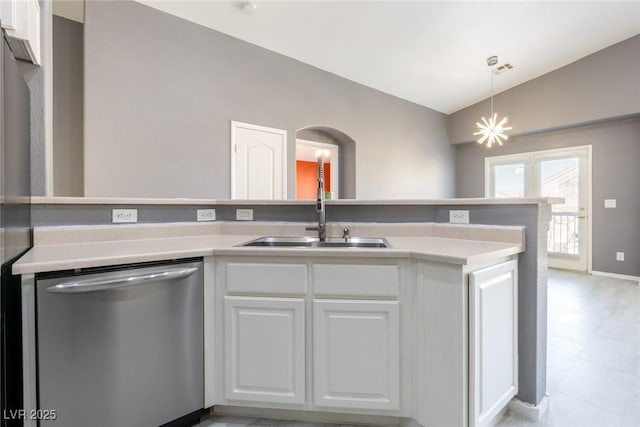 kitchen with vaulted ceiling, a sink, stainless steel dishwasher, white cabinets, and arched walkways