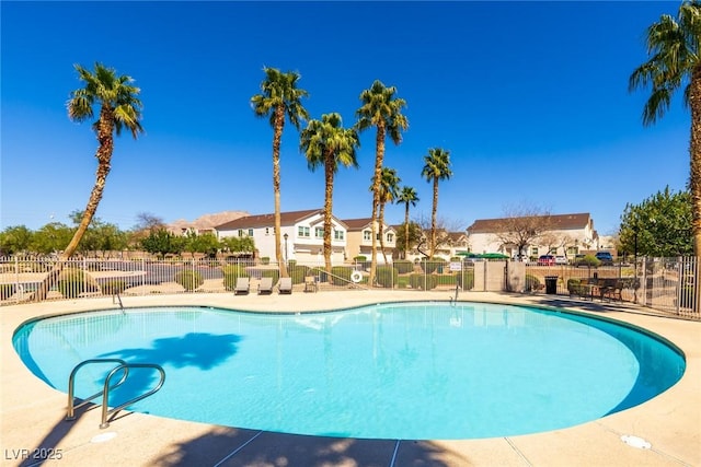 pool featuring fence and a residential view