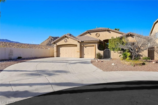 mediterranean / spanish-style home featuring a garage, fence, driveway, a tiled roof, and stucco siding