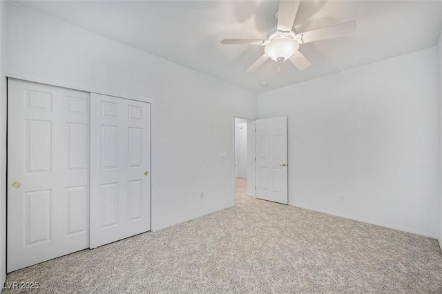 unfurnished bedroom featuring a ceiling fan, carpet, and a closet