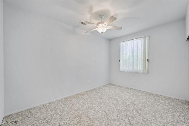 spare room featuring ceiling fan, carpet floors, and baseboards