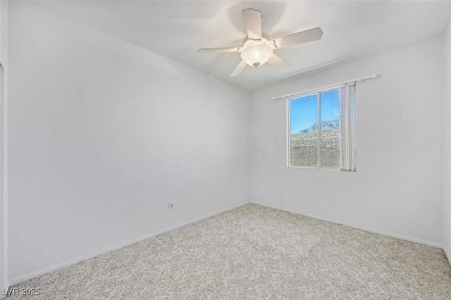 spare room featuring ceiling fan and carpet flooring