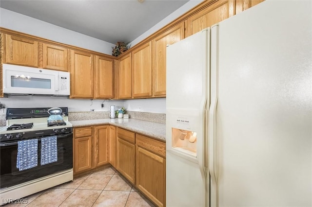 kitchen with light countertops, white appliances, and light tile patterned flooring