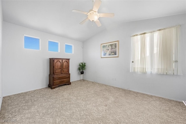 carpeted empty room with lofted ceiling and ceiling fan