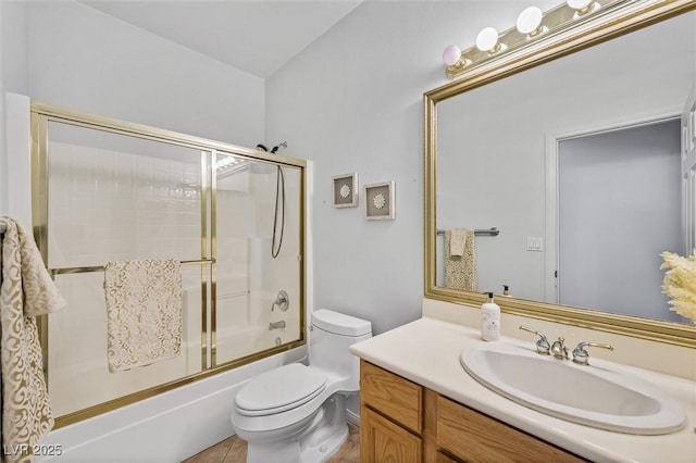 full bathroom featuring vanity, toilet, and bath / shower combo with glass door