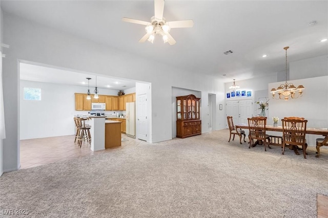 living area with light carpet, visible vents, ceiling fan with notable chandelier, and recessed lighting