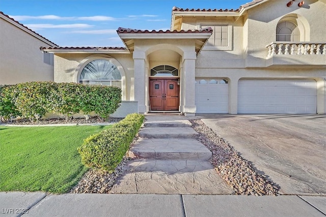 view of front of home featuring an attached garage, driveway, and stucco siding