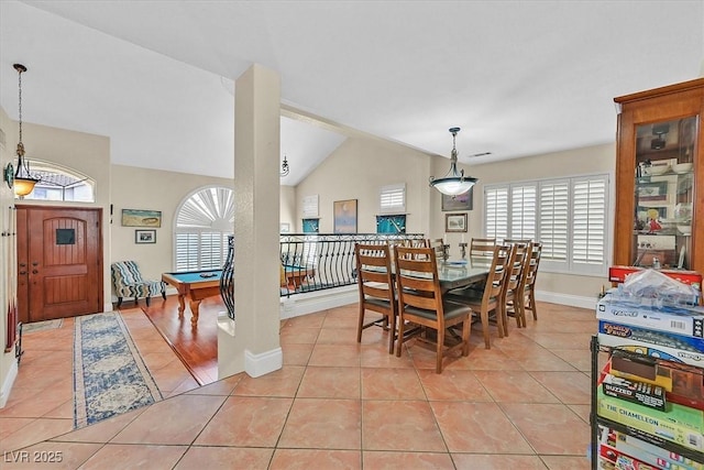 dining area with light tile patterned floors, lofted ceiling, and a healthy amount of sunlight