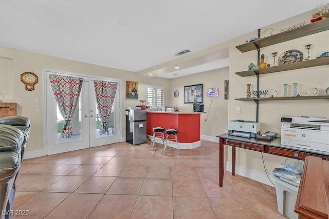 office area featuring light tile patterned flooring, french doors, visible vents, and baseboards