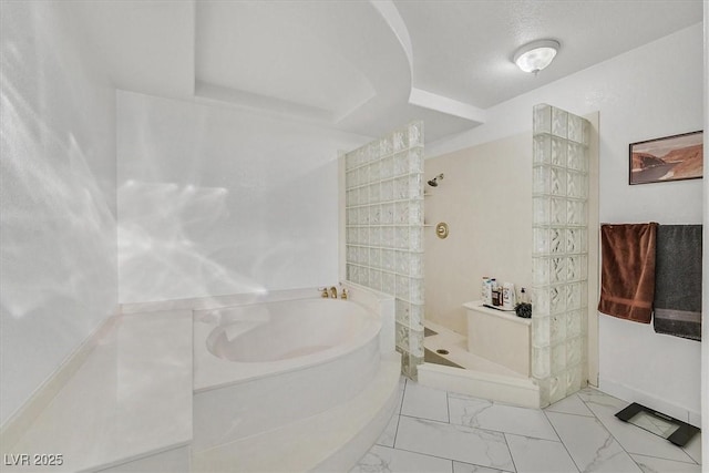 full bathroom featuring a bath, a walk in shower, and marble finish floor