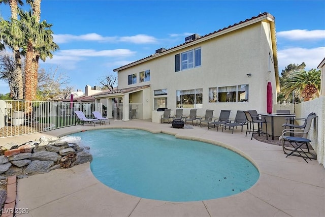 view of pool featuring a fire pit, a patio, and fence