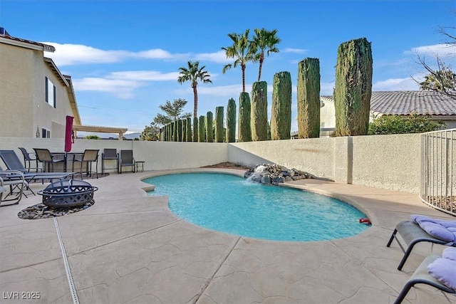 view of swimming pool featuring a patio area, a fenced in pool, an outdoor fire pit, and a fenced backyard