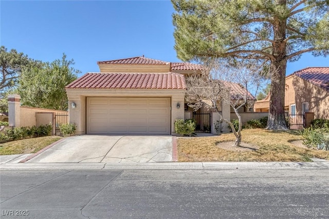 mediterranean / spanish home with an attached garage, fence, a tiled roof, concrete driveway, and stucco siding