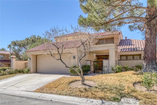 mediterranean / spanish home featuring a tile roof, stucco siding, an attached garage, a gate, and driveway