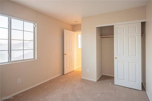 unfurnished bedroom featuring a closet, carpet flooring, and baseboards