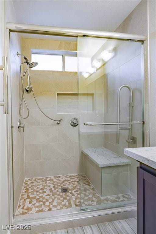 full bath featuring a stall shower and vanity