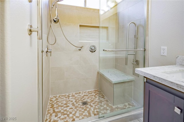 full bathroom with a shower stall and vanity