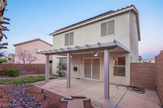 rear view of property with a patio area, a fenced backyard, a pergola, and stucco siding