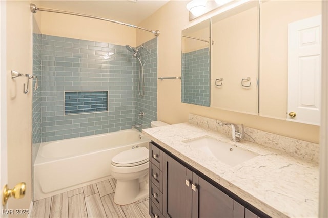 full bath featuring shower / washtub combination, wood finish floors, vanity, and toilet