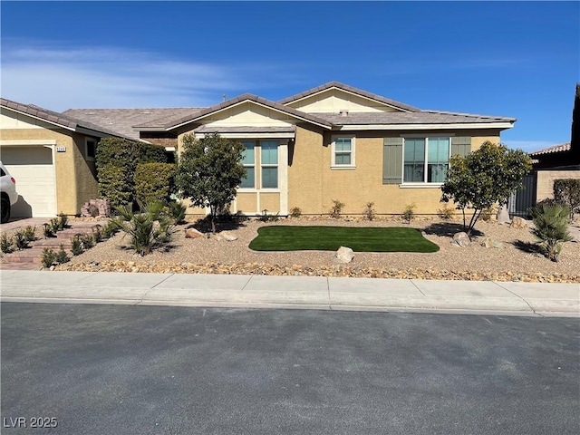 ranch-style home featuring an attached garage, a tile roof, a front yard, and stucco siding