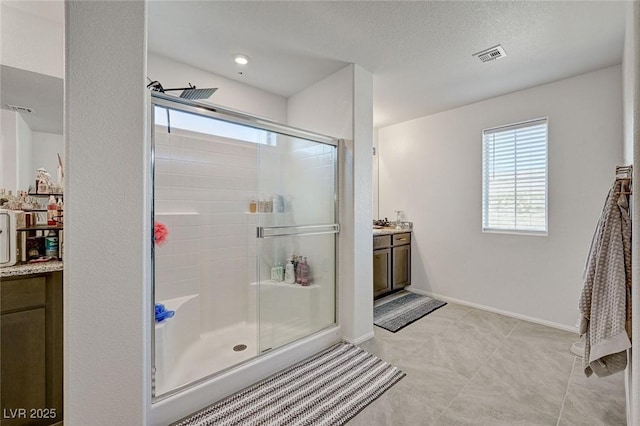 6747 Marjoram St, Las Vegas, NV 89166 - full bathroom featuring vanity, a shower stall, baseboards, and a textured ceiling