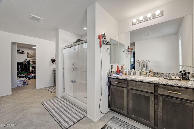 6747 Marjoram St, Las Vegas, NV 89166 - full bath with a shower stall, vanity, a walk in closet, and tile patterned floors