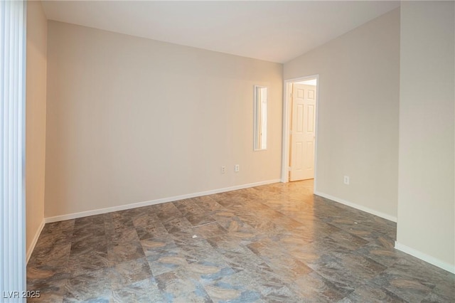 unfurnished room with baseboards