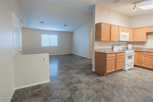 kitchen featuring white appliances, baseboards, and visible vents