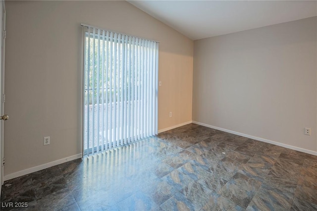 unfurnished room with lofted ceiling, a healthy amount of sunlight, and baseboards