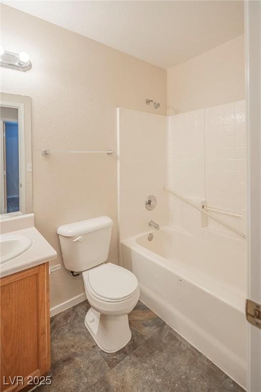 bathroom with baseboards, shower / tub combination, vanity, and toilet