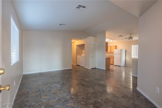 unfurnished living room with vaulted ceiling, separate washer and dryer, visible vents, and a ceiling fan