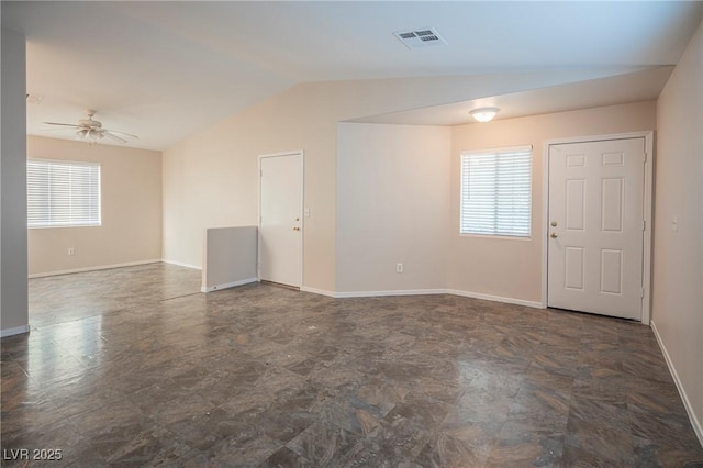 empty room with lofted ceiling, visible vents, plenty of natural light, and ceiling fan