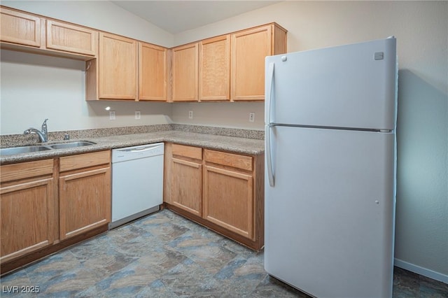 kitchen featuring white appliances, light brown cabinets, light countertops, and a sink