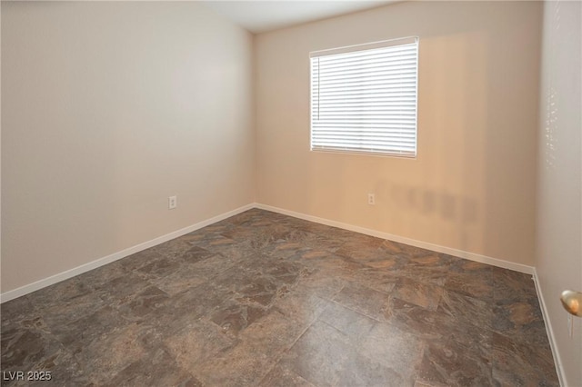 spare room featuring baseboards