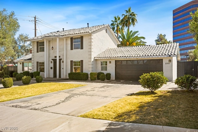 view of front of home featuring a garage, driveway, a tile roof, a front lawn, and stucco siding