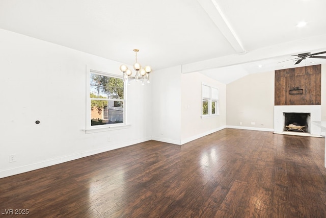 unfurnished living room with a healthy amount of sunlight, a large fireplace, vaulted ceiling with beams, and wood finished floors