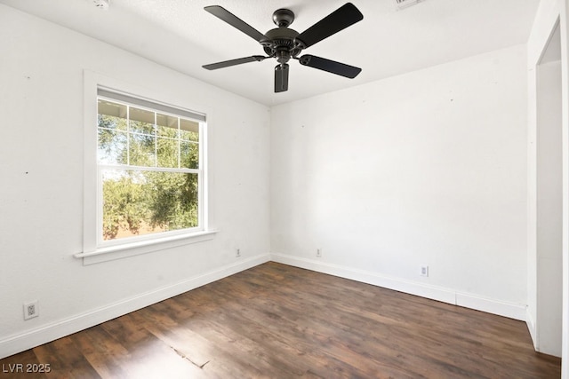 empty room with visible vents, dark wood finished floors, baseboards, and ceiling fan