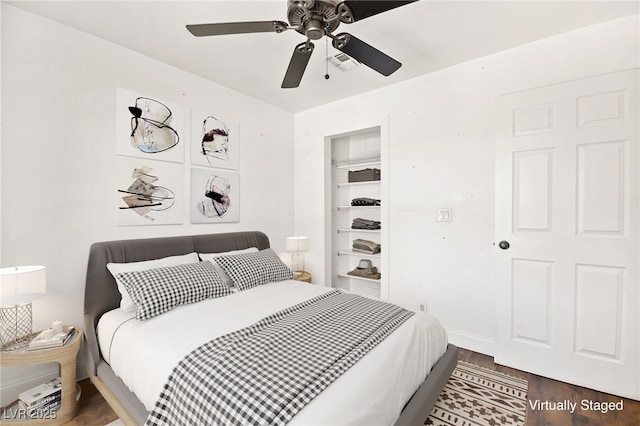 bedroom with baseboards, visible vents, ceiling fan, and wood finished floors