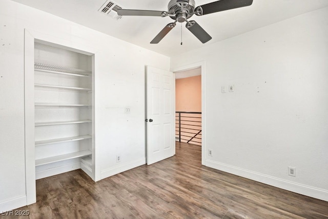 unfurnished bedroom with visible vents, baseboards, ceiling fan, wood finished floors, and a closet