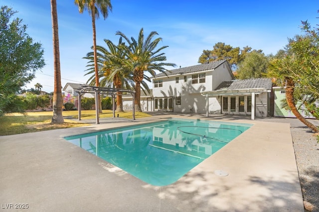 outdoor pool with a patio area and a pergola