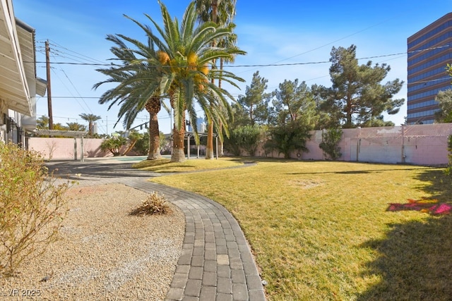 view of yard featuring fence and a pergola