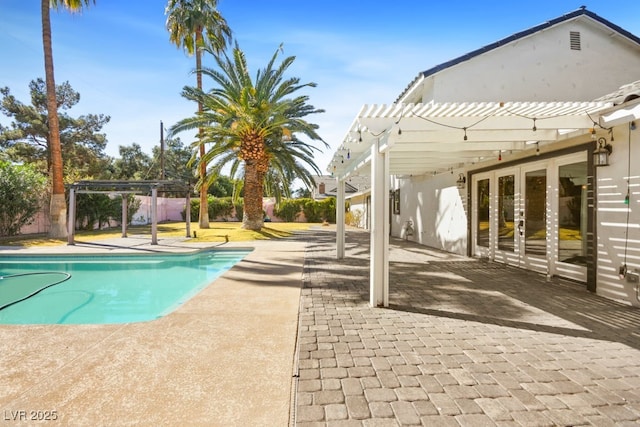 view of swimming pool featuring a patio, fence, a fenced in pool, and a pergola